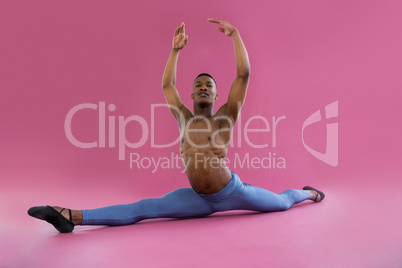 Portrait of ballerino performing a split
