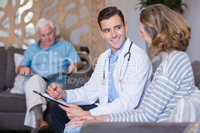 Doctor discussing a medical report with woman