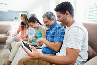 Multi-generation family using digital tablet in living room