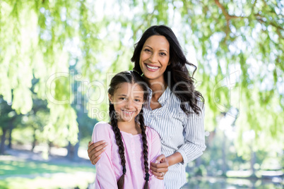 Mother standing with her daughter in park
