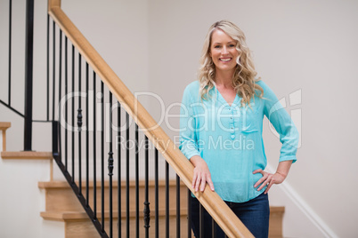 Smiling beautiful woman standing with hand on hip