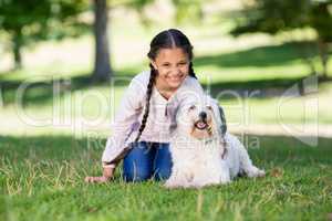 Portrait of smiling girl playing with her pet dog