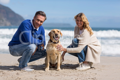 Mature couple petting their dog