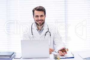 Portrait of male doctor checking medicine