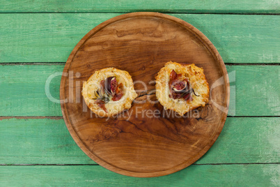 Delicious pizza served on pizza tray on wooden plank