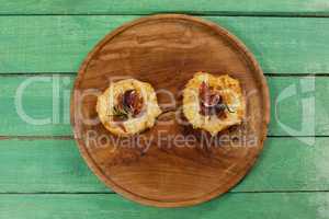 Delicious pizza served on pizza tray on wooden plank