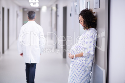 Pregnant woman standing in corridor