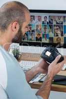 Male photographer reviewing captured photos in his digital camera