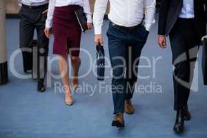 Business executives walking in a conference center lobby