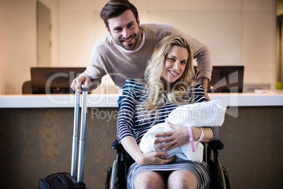 Portrait of couple holding their newborn baby