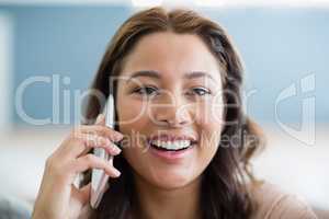 Portrait of smiling woman talking on mobile phone