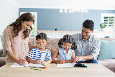 Parents assisting their kids in doing homework
