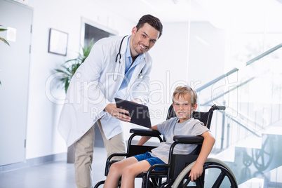 Doctor showing digital tablet to  disable boy