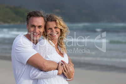 Mature couple embracing each other on the beach