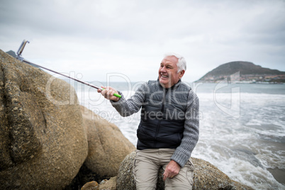 Senior man taking a selfie from selfie stick