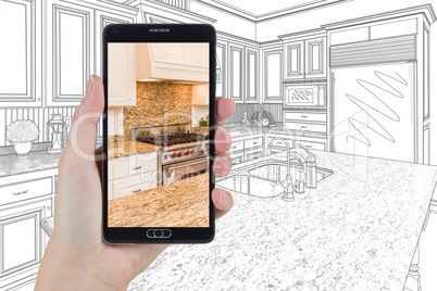 Hand Holding Smart Phone Displaying Photo of Kitchen Drawing Beh