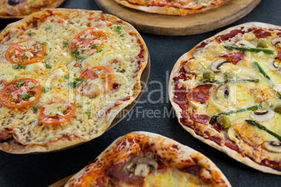 Various pizza arranged on a wooden tray