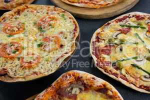 Various pizza arranged on a wooden tray