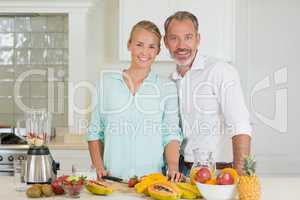 Smiling couple standing in kitchen