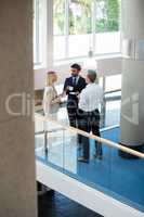 Business executives interacting with each other while having coffee