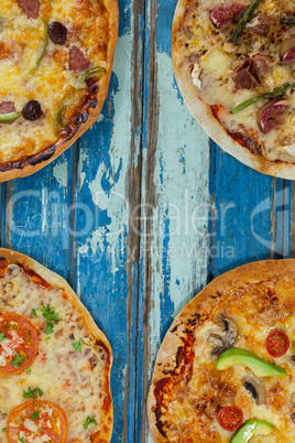 Various italian pizza served on wooden plank