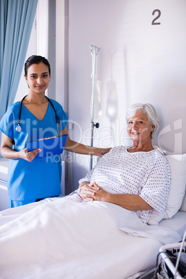 Female doctor and senior patient smiling