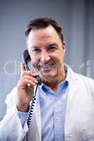 Portrait of male doctor interacting on phone
