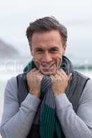 Smiling mature man standing on the beach