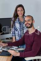 Photographer working at his desk with colleague