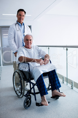Portrait of doctor smiling with senior patient on a wheelchair