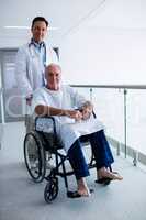 Portrait of doctor smiling with senior patient on a wheelchair