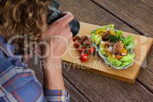 Photographer clicking a picture of food using digital camera