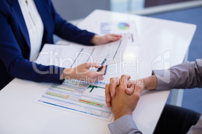 Business executives discussing over document
