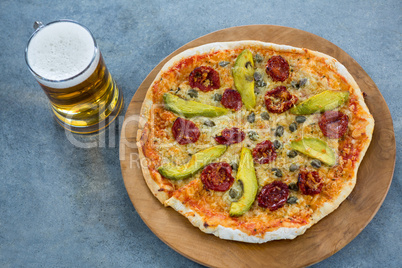 Italian pizza served with a mug of beer