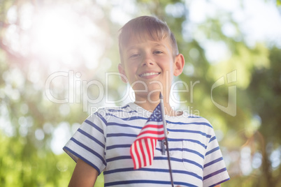 Boy holding small american flag