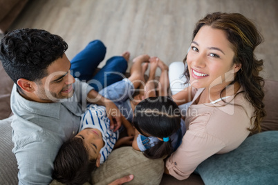 Parents and kids having fun in living room