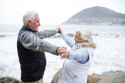 Senior couple having fun together at beach