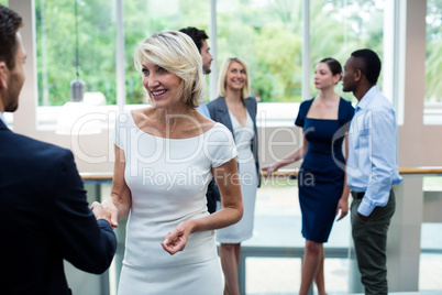 Business executives shaking hands with each other Business executives shaking hands with each other