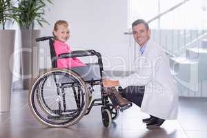 Portrait of smiling doctor and disable girl