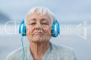 Senior woman listening to music on headphones