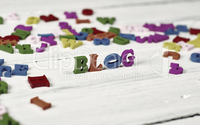 Colorful wooden letters on a white surface