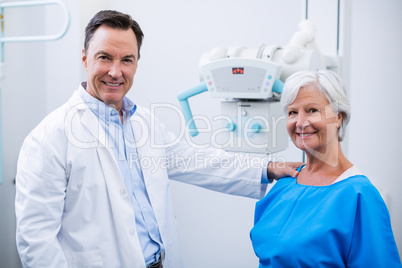 Portrait of smiling doctor and senior woman during medical check-up