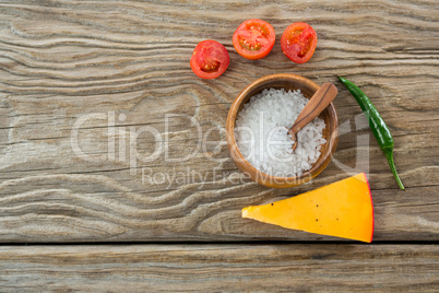 Tomatoes, cheese, chilli with salt on a bowl