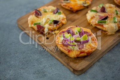 Various pizza arranged on a wooden tray Various pizza arranged on a wooden tray