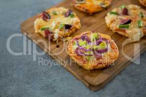 Various pizza arranged on a wooden tray