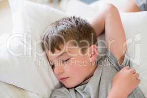 Cute boy sleeping on bed in bedroom