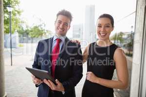 Businessman and colleague holding digital tablet