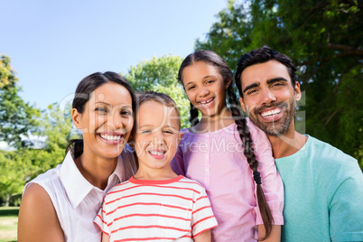Portrait of happy family enjoying time together in the park