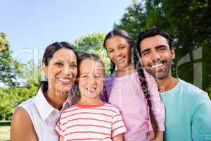 Portrait of happy family enjoying time together in the park