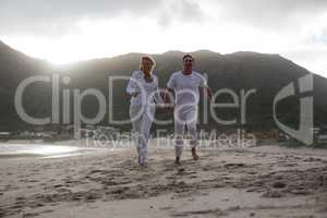 Mature couple running on the beach